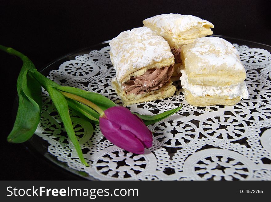 Delicious pastry puffs on a paper lace doily.