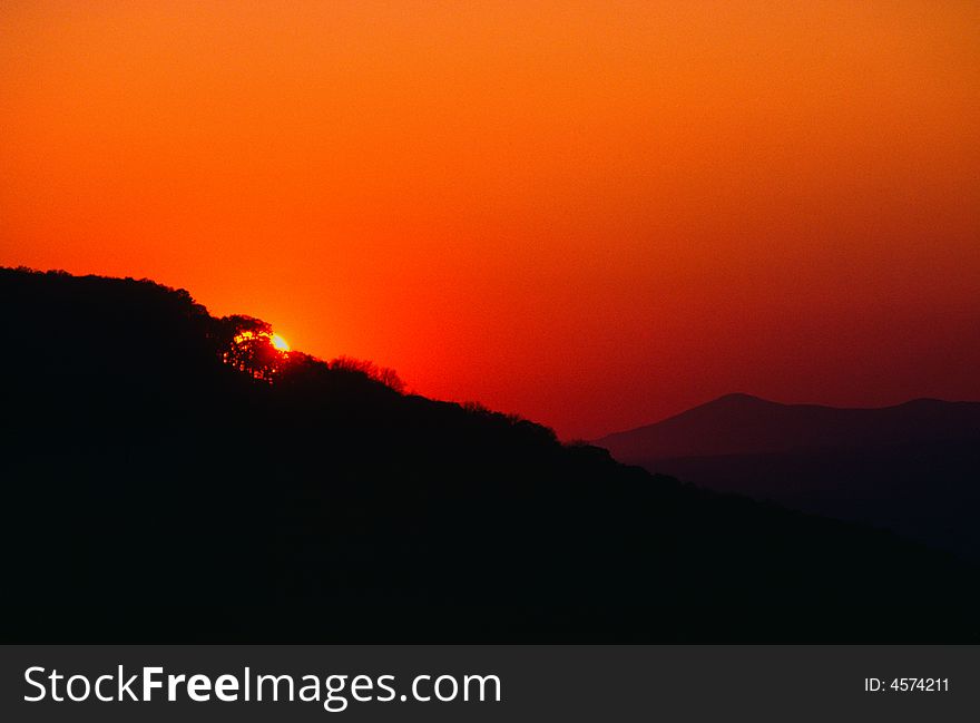 Smoke from forest fires colored red by setting sun as it set behind Magazine Mountain. Smoke from forest fires colored red by setting sun as it set behind Magazine Mountain