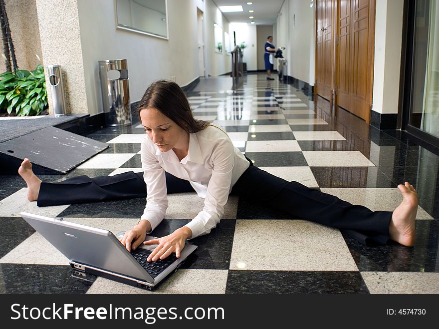 Woman on the floor working on her laptop. Woman on the floor working on her laptop