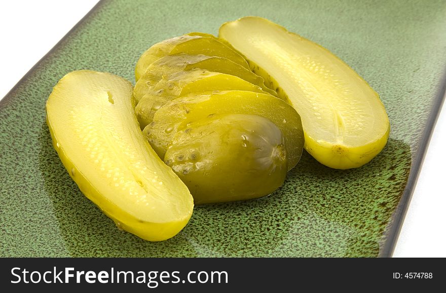 Sliced full sour pickles on a plate. Sliced full sour pickles on a plate.