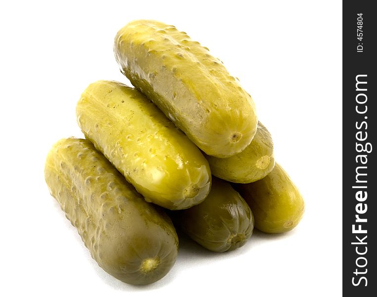 Pyramid of full sour pickles isolated on white background.