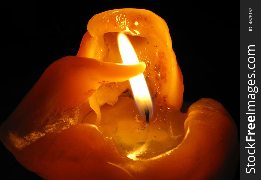 Wax from left side looks like arm trying to protect the flame. Wax from left side looks like arm trying to protect the flame.