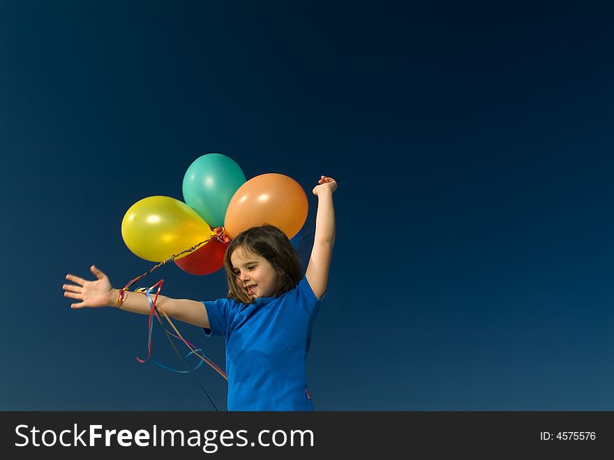 Girl holding balloons against blue sky. Girl holding balloons against blue sky