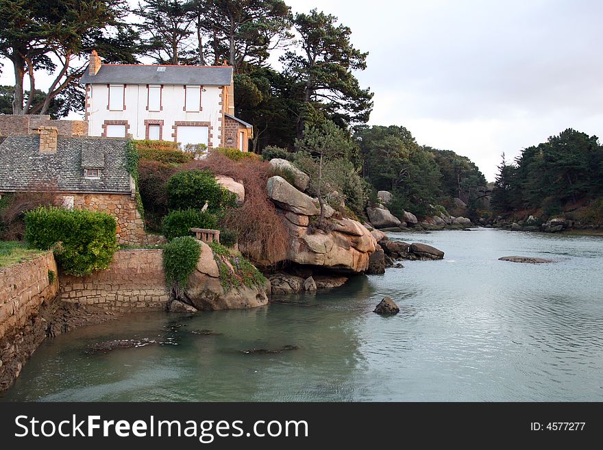 House along a rocky river in brittany