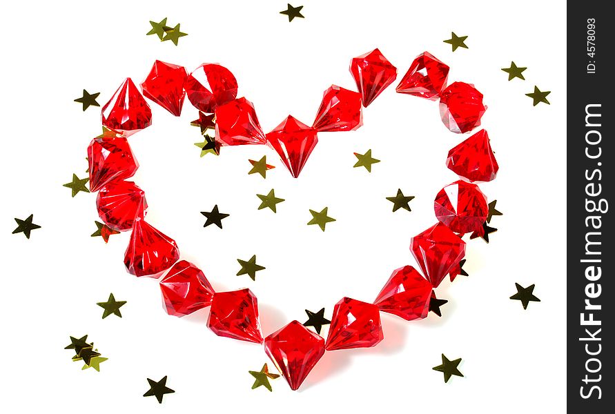 Red gems lying in heart shape with gold stars isolated on white perfect for inserting custom message. Red gems lying in heart shape with gold stars isolated on white perfect for inserting custom message