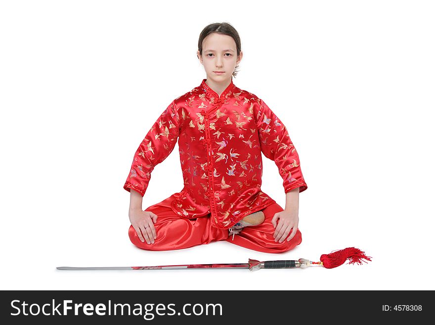 Wushu girl with sword sits on white