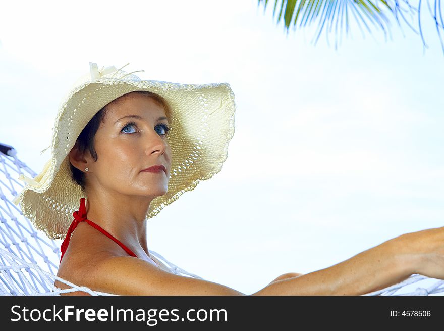 View of nice woman lounging in hammock in tropical environment. View of nice woman lounging in hammock in tropical environment