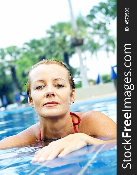 Portrait of nice young woman relaxing in swimming pool. Portrait of nice young woman relaxing in swimming pool