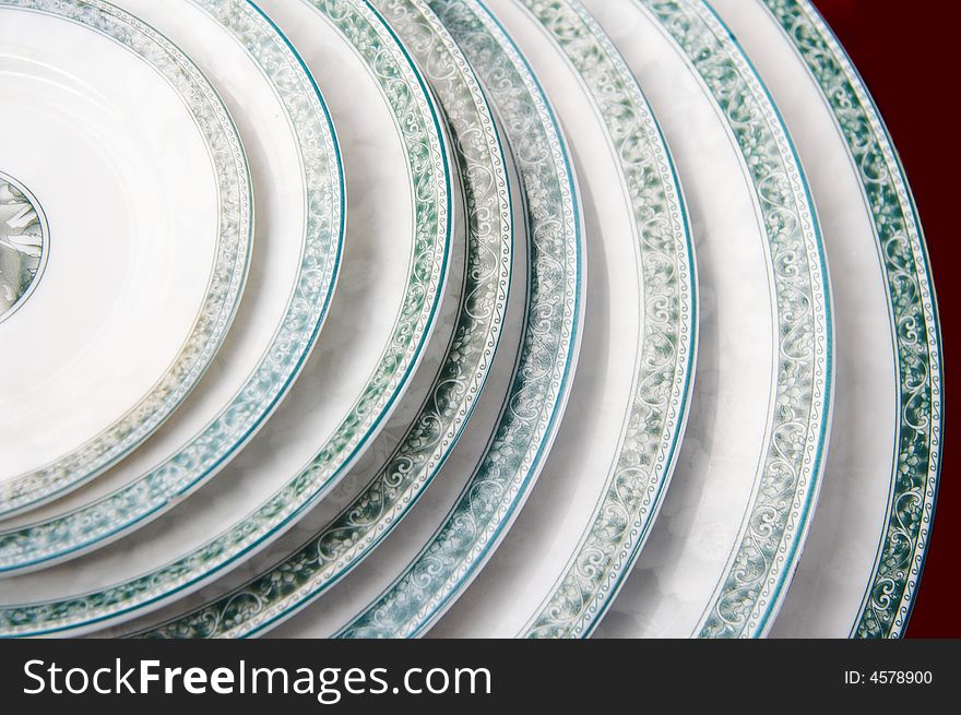 A pile of plates,same style,different size,displaying on sale. A pile of plates,same style,different size,displaying on sale