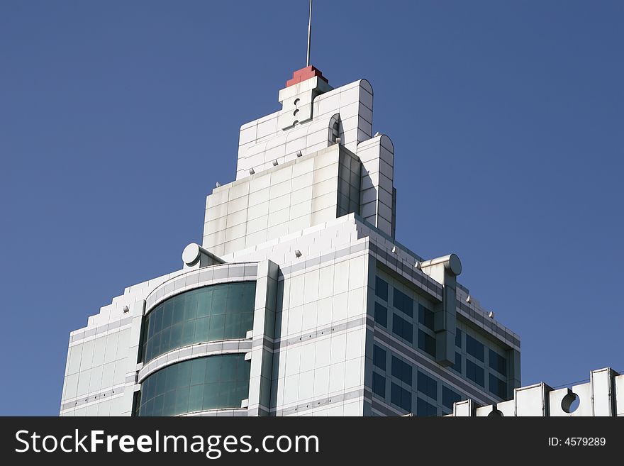 Green office building under clear blue sky