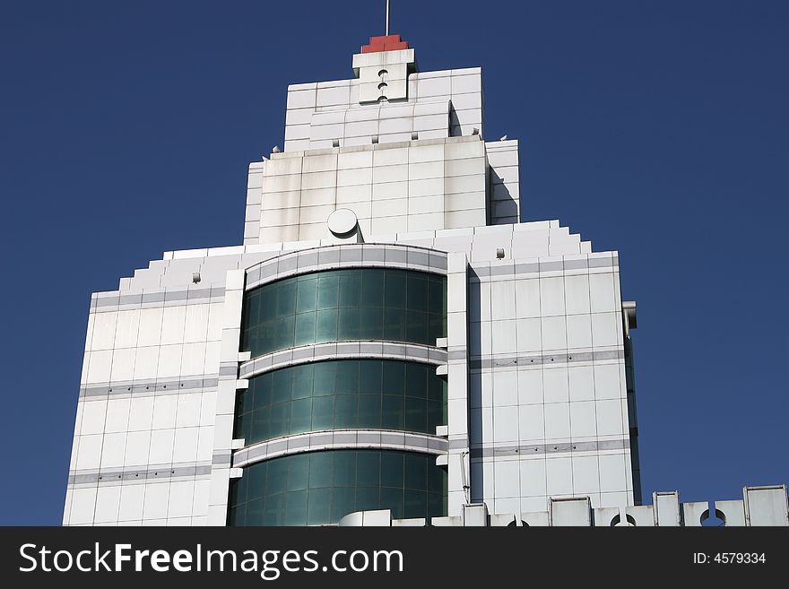 Green office building under clear blue sky