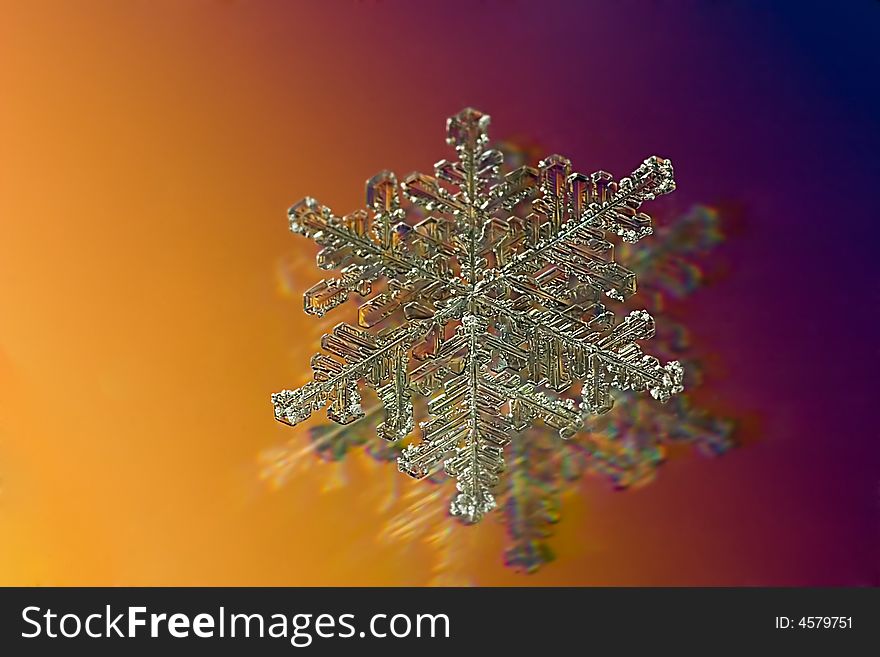 Small snowflake on yellow and red background