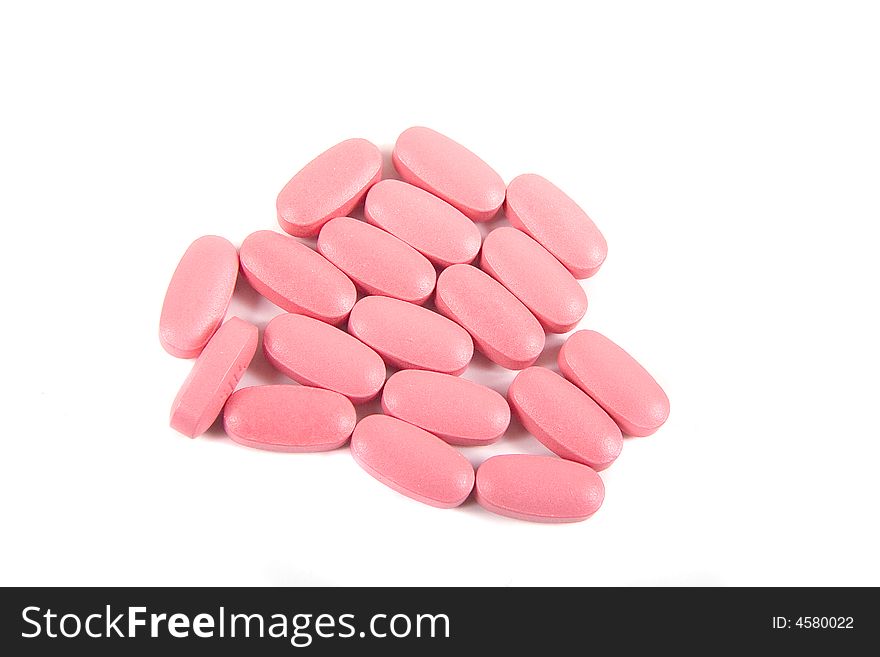Pink tablets or medicine on a white background