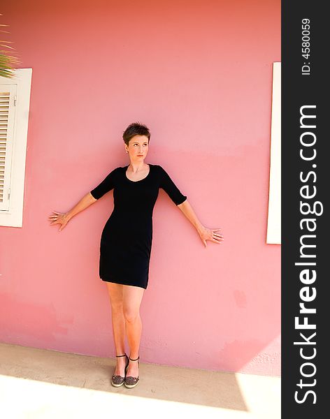 Photo of young woman in front of the wall.