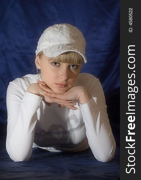 Girl in white cap on blue background