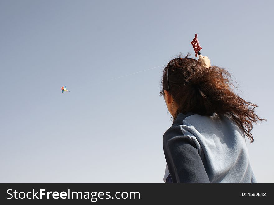 Young woman fly a kite. Young woman fly a kite