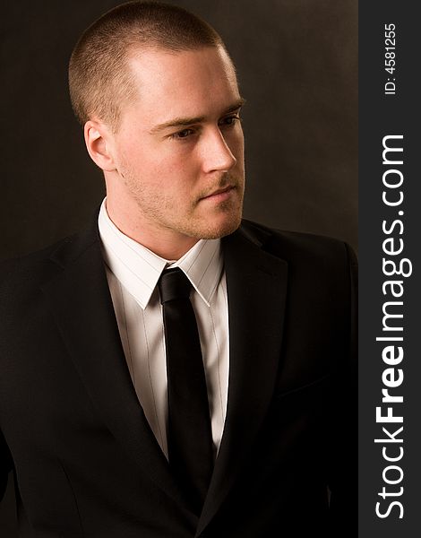 Portrait of a young businessman on dark background. Portrait of a young businessman on dark background