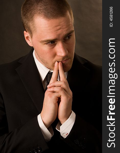 Portrait of a young businessman on dark background. Portrait of a young businessman on dark background