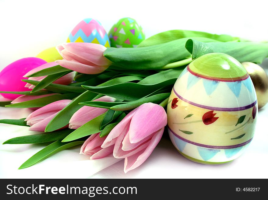 Colorful Easter eggs, tulips, bucket