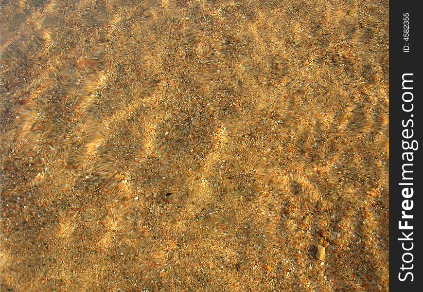 Sand under clear water glittering on sun. Sand under clear water glittering on sun
