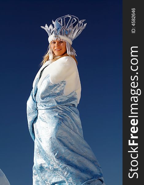 Happy majestic snow queen over blue sky