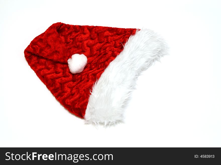 Folded santa claus hat on a white surface. Folded santa claus hat on a white surface
