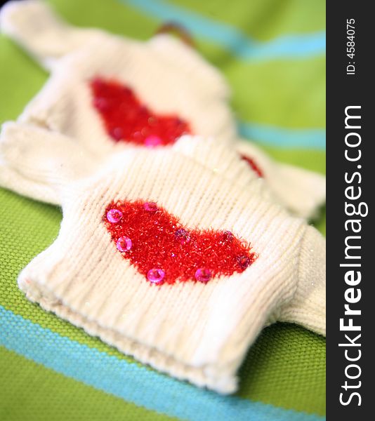 Tiny sweaters with knitted hearts. Tiny sweaters with knitted hearts.