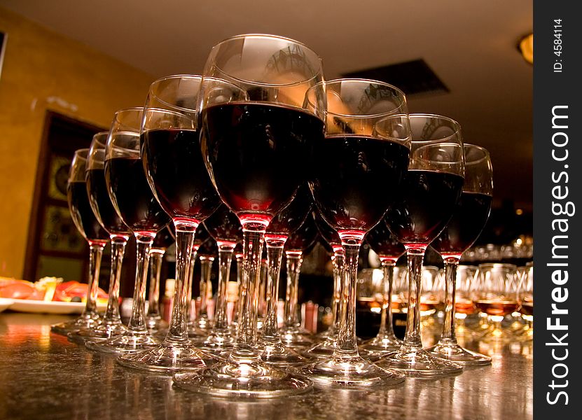 Glasses with wine on an ablaze background