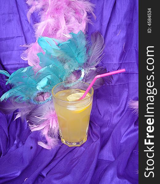 Yellow carnival drink on the purple back ground. Yellow carnival drink on the purple back ground