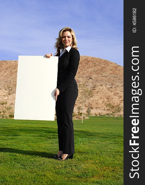 Portrait of a confident and successful businesswoman holding blank board. Portrait of a confident and successful businesswoman holding blank board