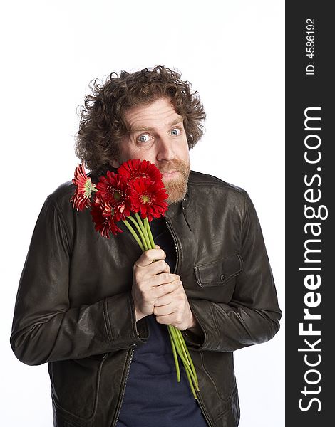 Man holding a bunch of flowers and looking apologetic. Man holding a bunch of flowers and looking apologetic