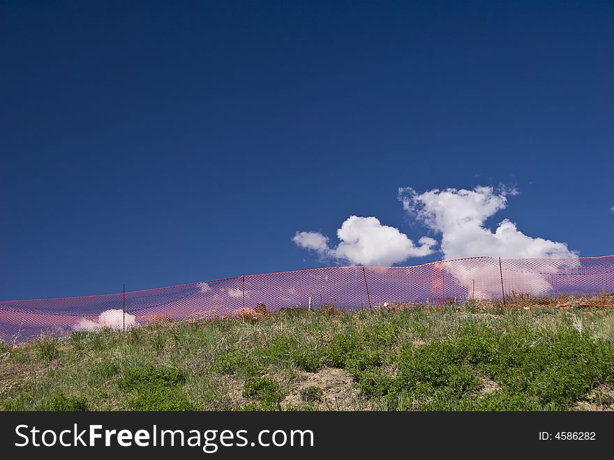 Construction Fence On Grassy Hill