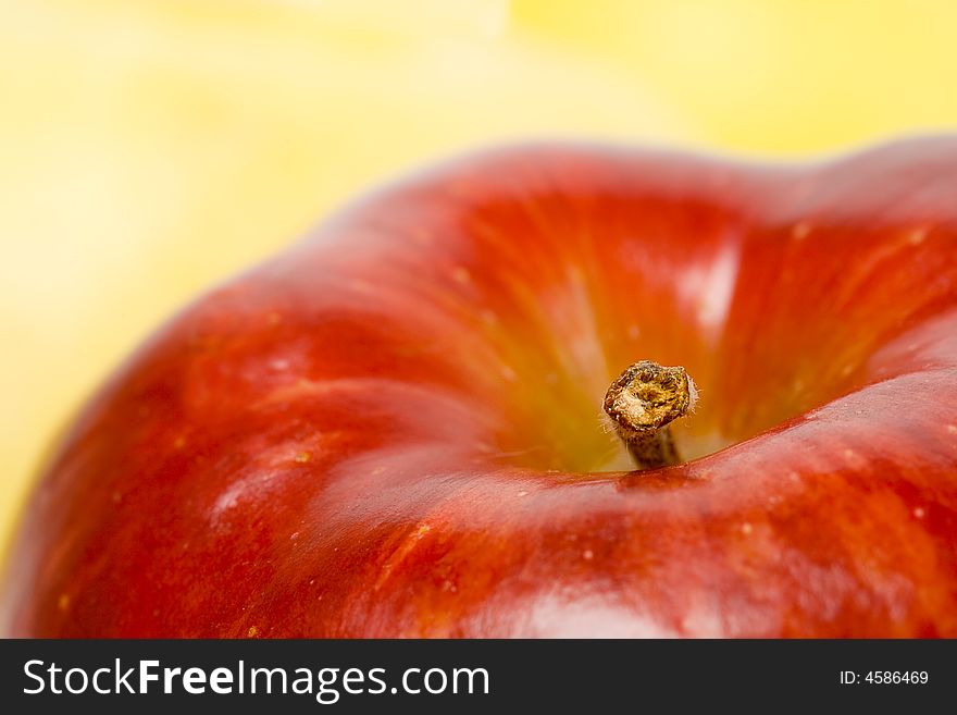 Closeup red apple with yellow background. Closeup red apple with yellow background