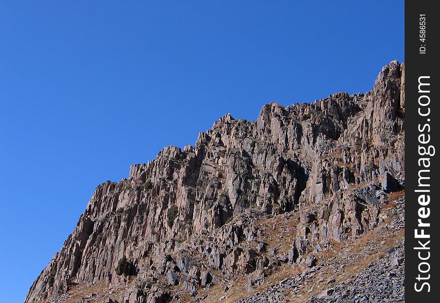 Grey rocks on blue sky background