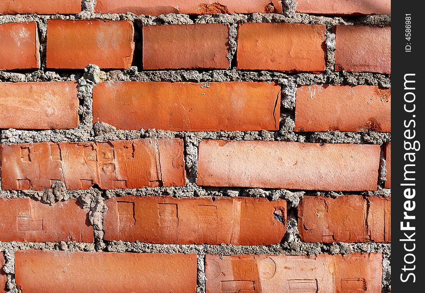 Old brick wall with bright orange bricks