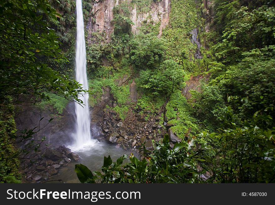 Spectacular waterfall and pool on lush tropical island. Spectacular waterfall and pool on lush tropical island