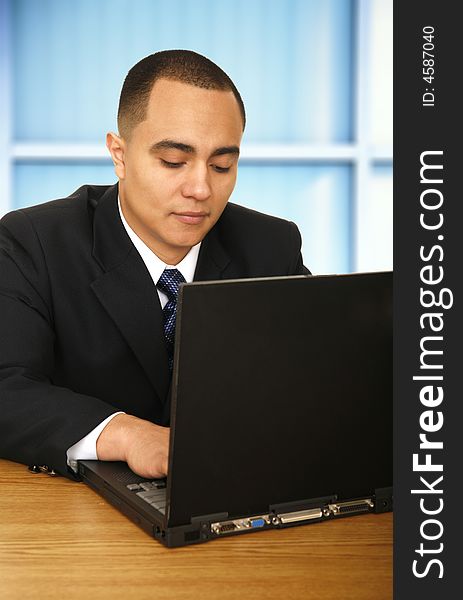 Business man working with his laptop in contemporary business environment. Business man working with his laptop in contemporary business environment