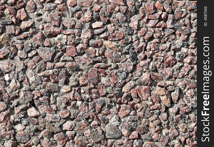 Sledged stone wall texture. Small pieses of rock.