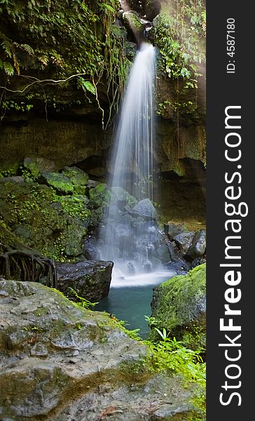 Spectacular waterfall and pool on lush tropical island. Spectacular waterfall and pool on lush tropical island