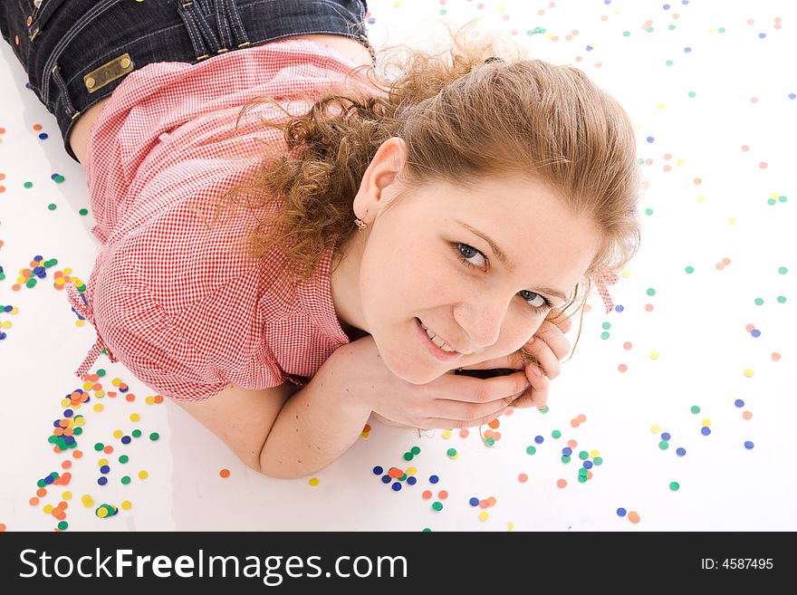The young beautiful girl with the confetti isolated on a white background. The young beautiful girl with the confetti isolated on a white background