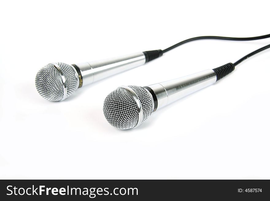 Two microphones with a black cord. Two microphones with a black cord.