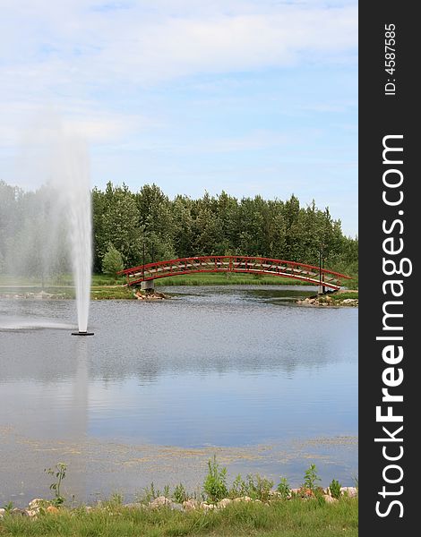 A large water fountain in a relaxing urban park setting. A large water fountain in a relaxing urban park setting