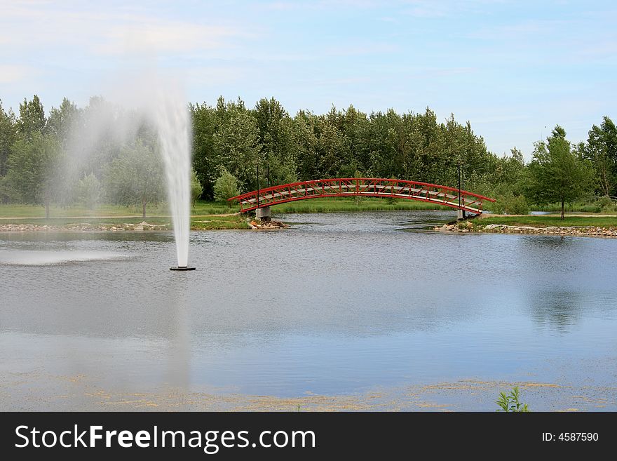 A large water fountain in a relaxing urban park setting. A large water fountain in a relaxing urban park setting