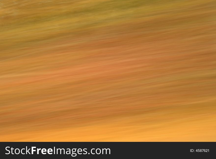 Abstract motion blur of Autumn trees from a moving vehicle. Abstract motion blur of Autumn trees from a moving vehicle
