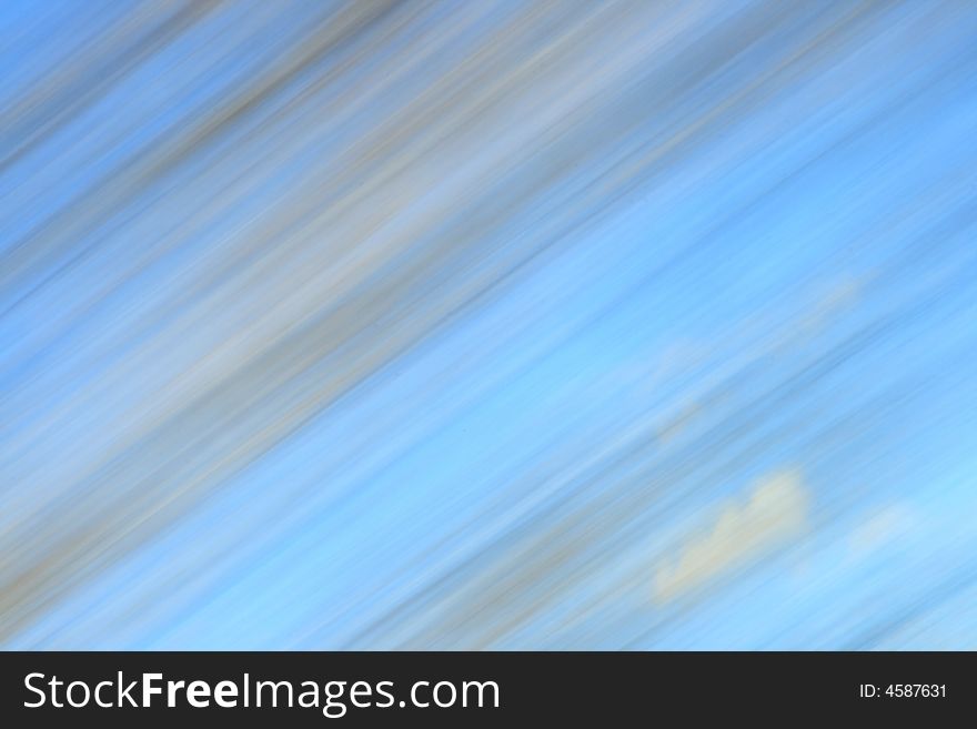 Abstract motion blur of Autumn trees and blue sky from a moving vehicle. Abstract motion blur of Autumn trees and blue sky from a moving vehicle
