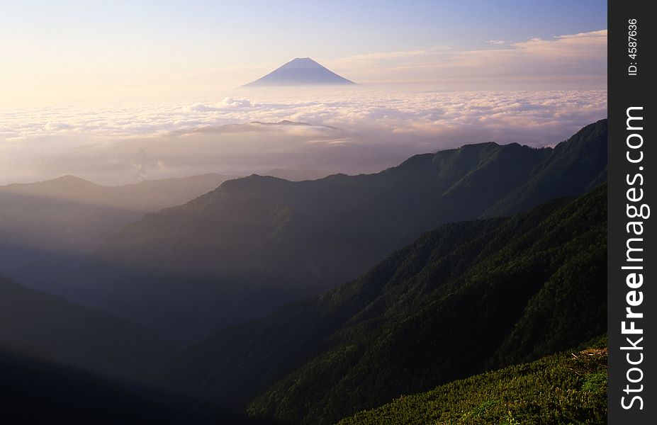 Majestic Mount Fuji rising through a sea of white clouds. Majestic Mount Fuji rising through a sea of white clouds