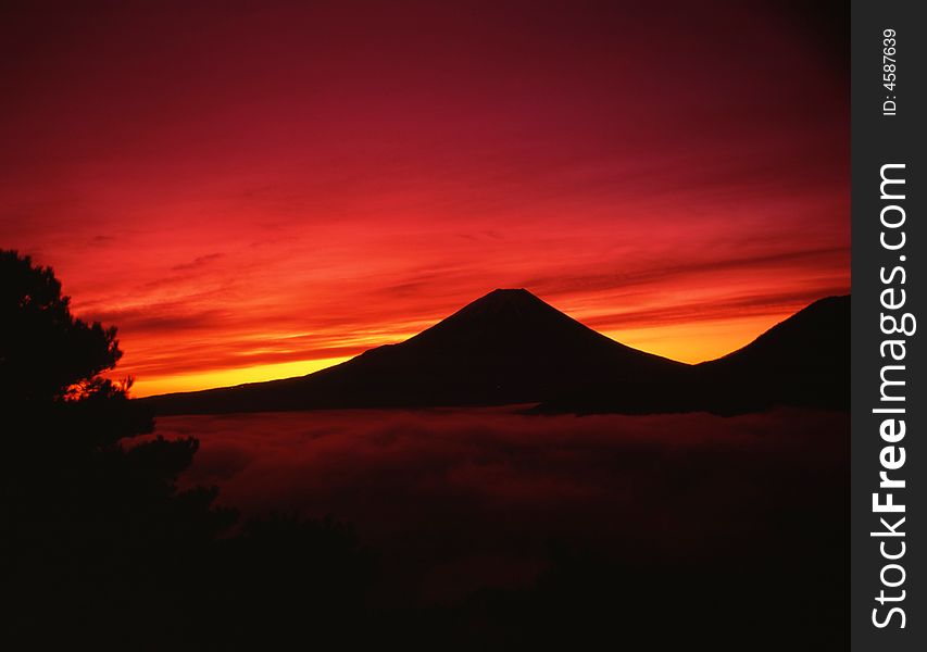 A fiery sunrise over the silhouette of sacred Fuji. A fiery sunrise over the silhouette of sacred Fuji