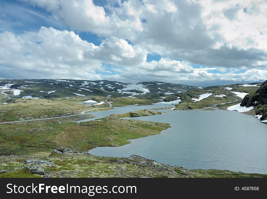 North landscape, road, snow and lake, Norway.