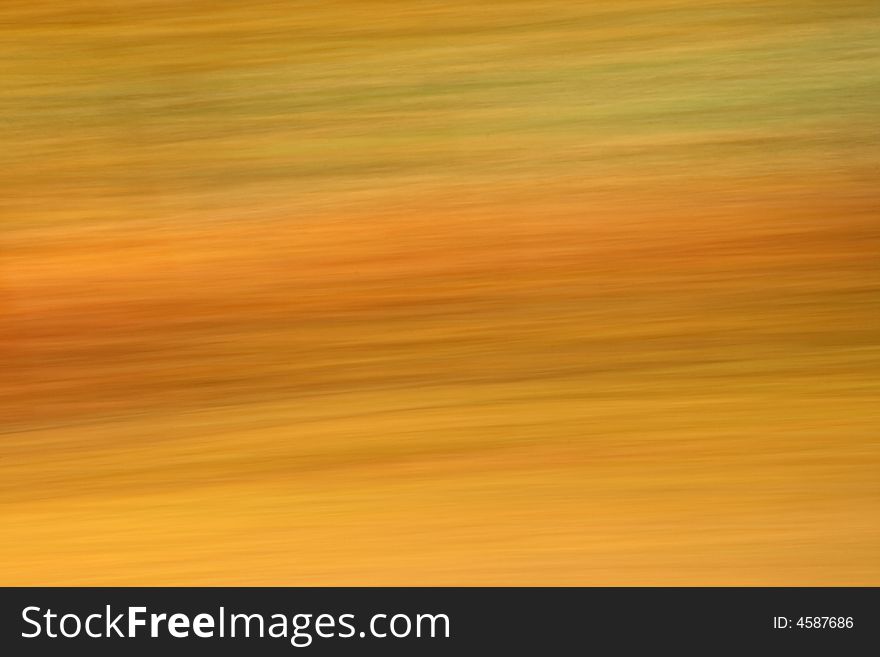 Abstract motion blur of Autumn trees from a moving vehicle. Abstract motion blur of Autumn trees from a moving vehicle