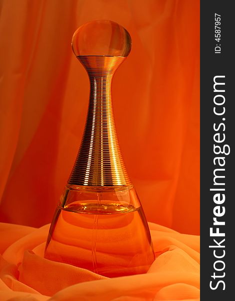 Spirits in a beautiful bottle on an orange background